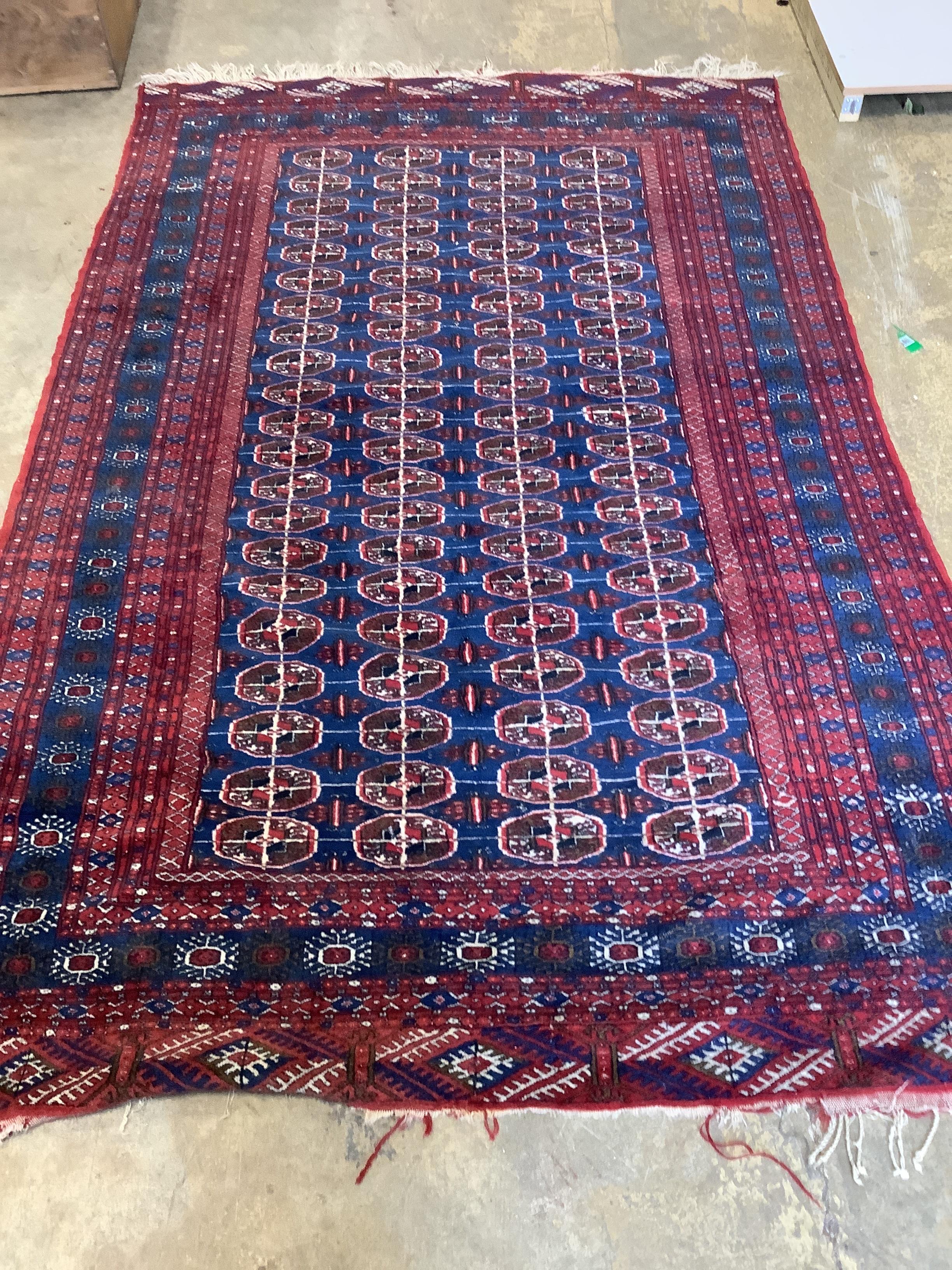 A Bokhara blue ground rug, 240 x 155cm